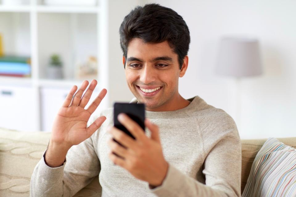 Man waving on video call.