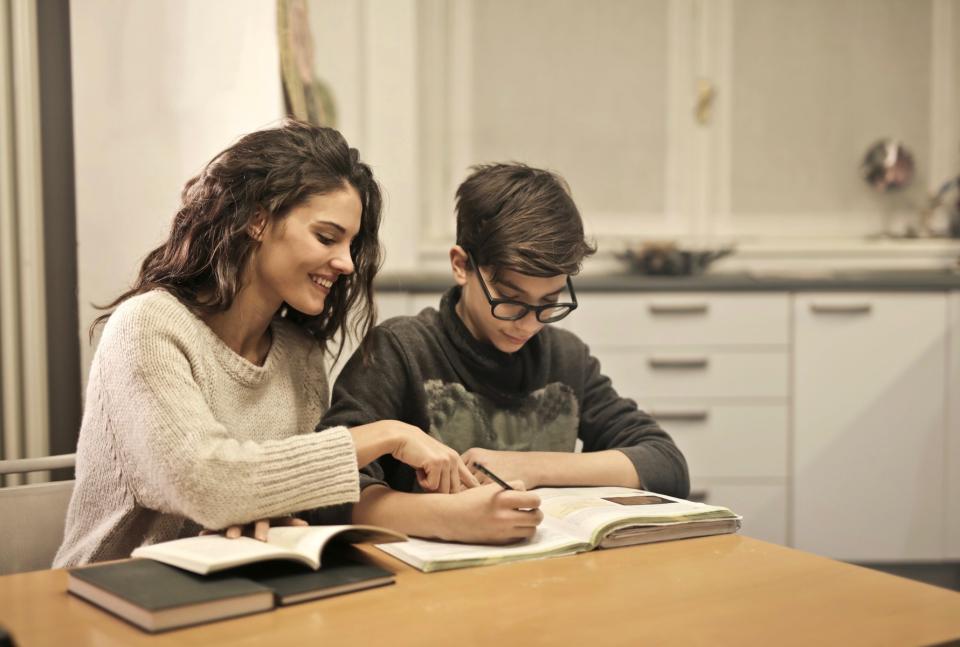Mom helping son with homework. 