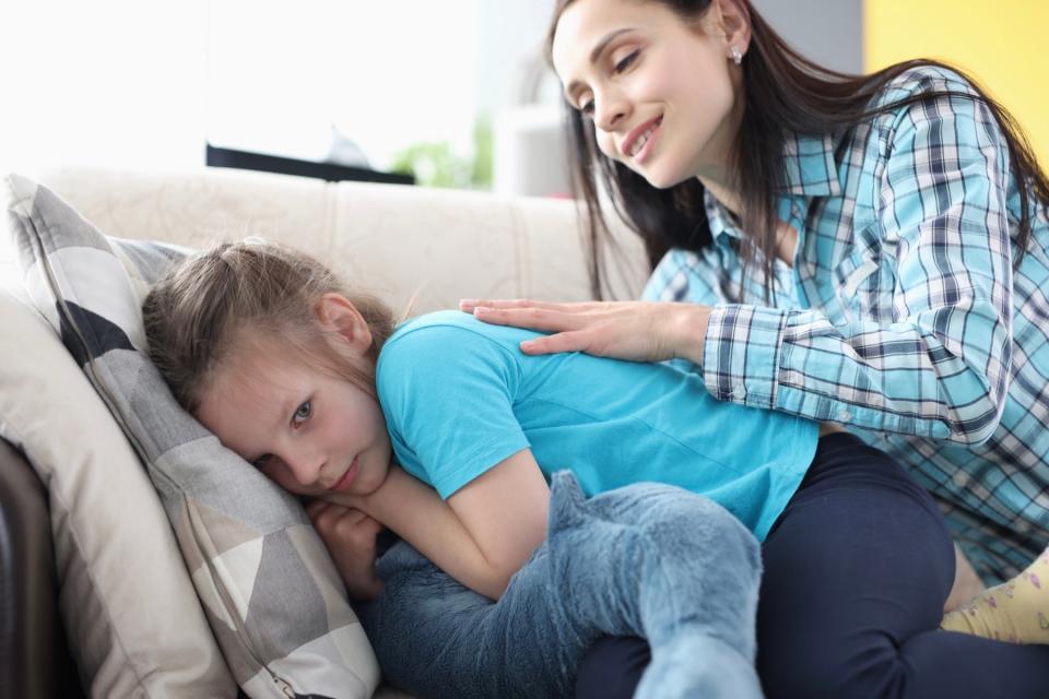 Mom trying to comfort daughter turning away from her.