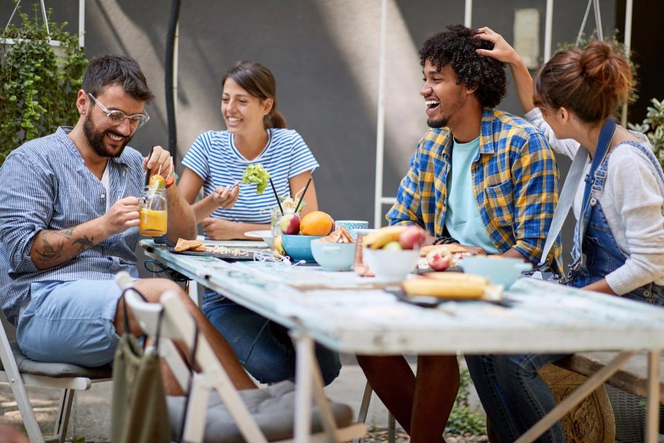 Friends sitting and eating healthy food.