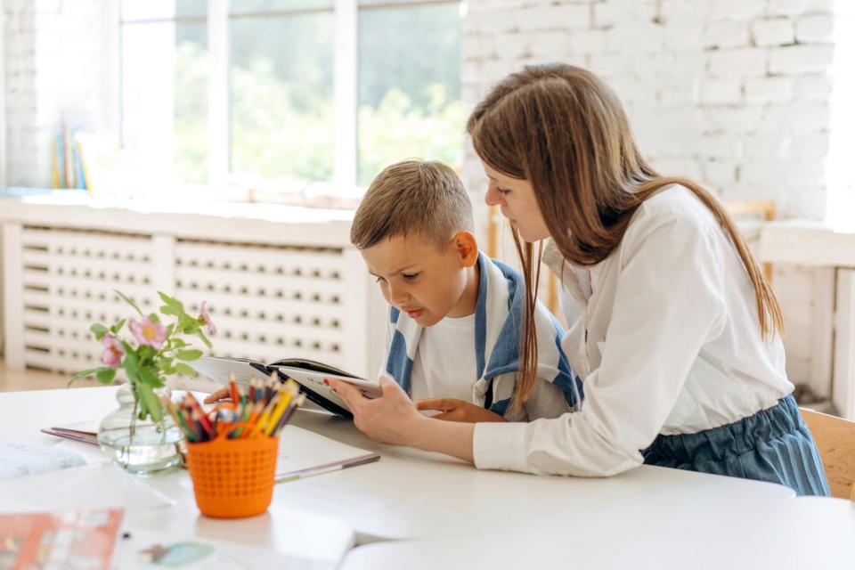 Mom and son reading a book.