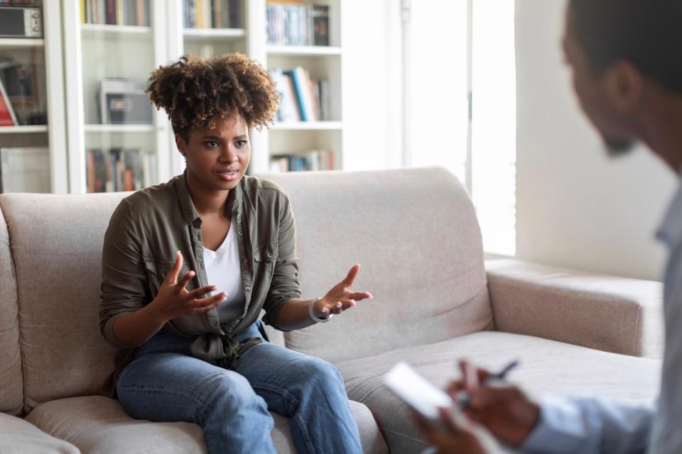 Woman talking to a male therapist.