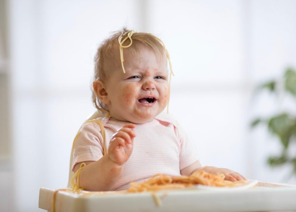 Toddler throwing a tantrum while eating. 