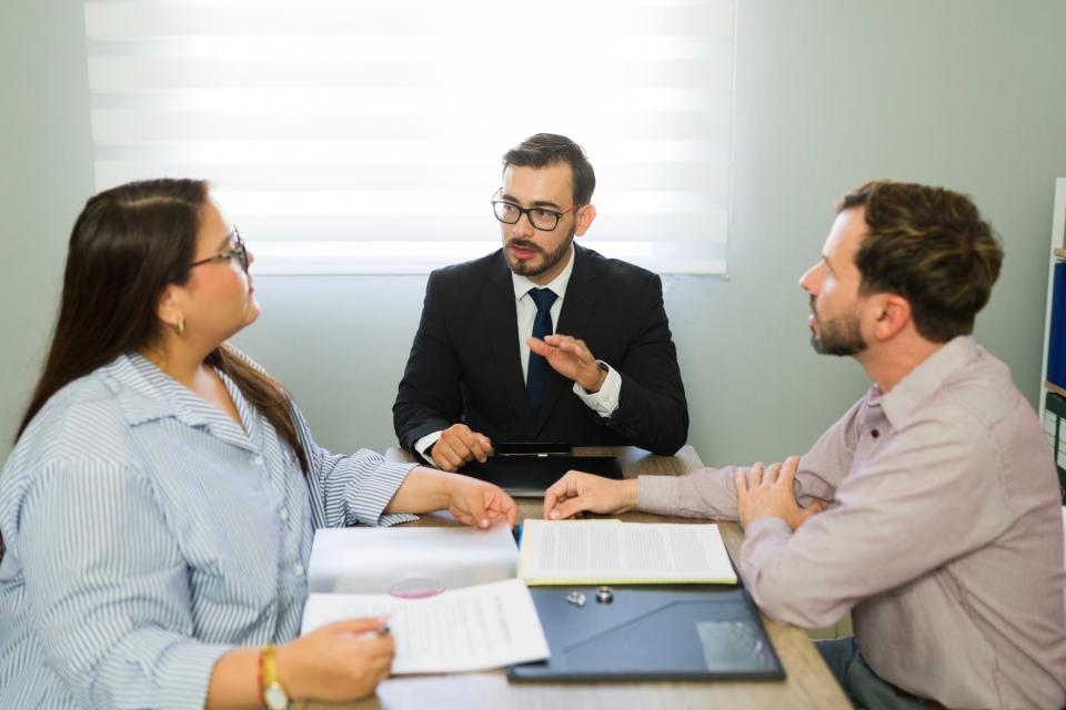 Man and woman meeting with an attorney. 