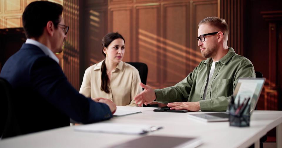 Man and woman meeting with mediator.