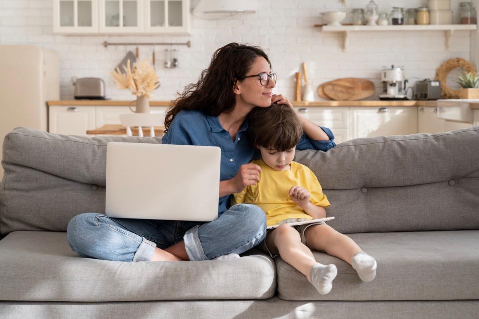 Mom hugging son on couch. 