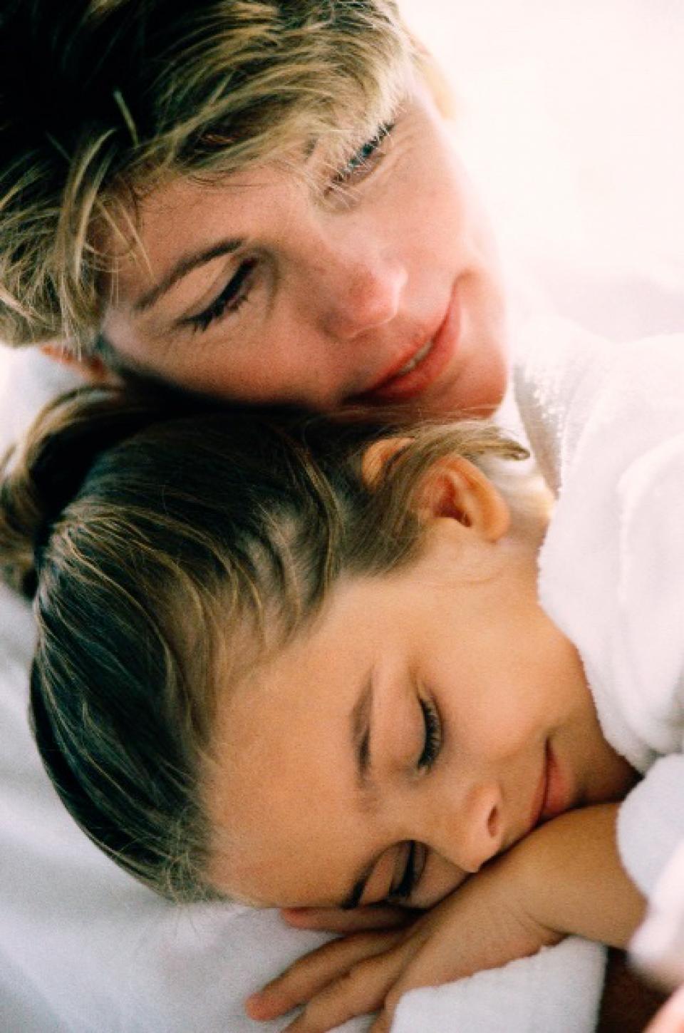 Mother hugging daughter
