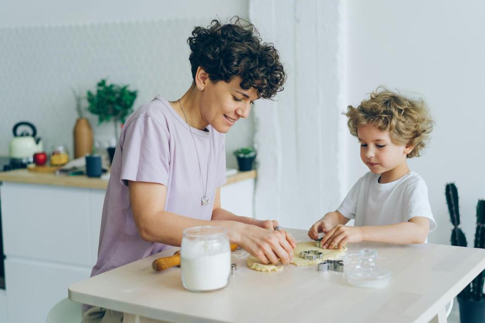 Mother and son making holiday cookies at home